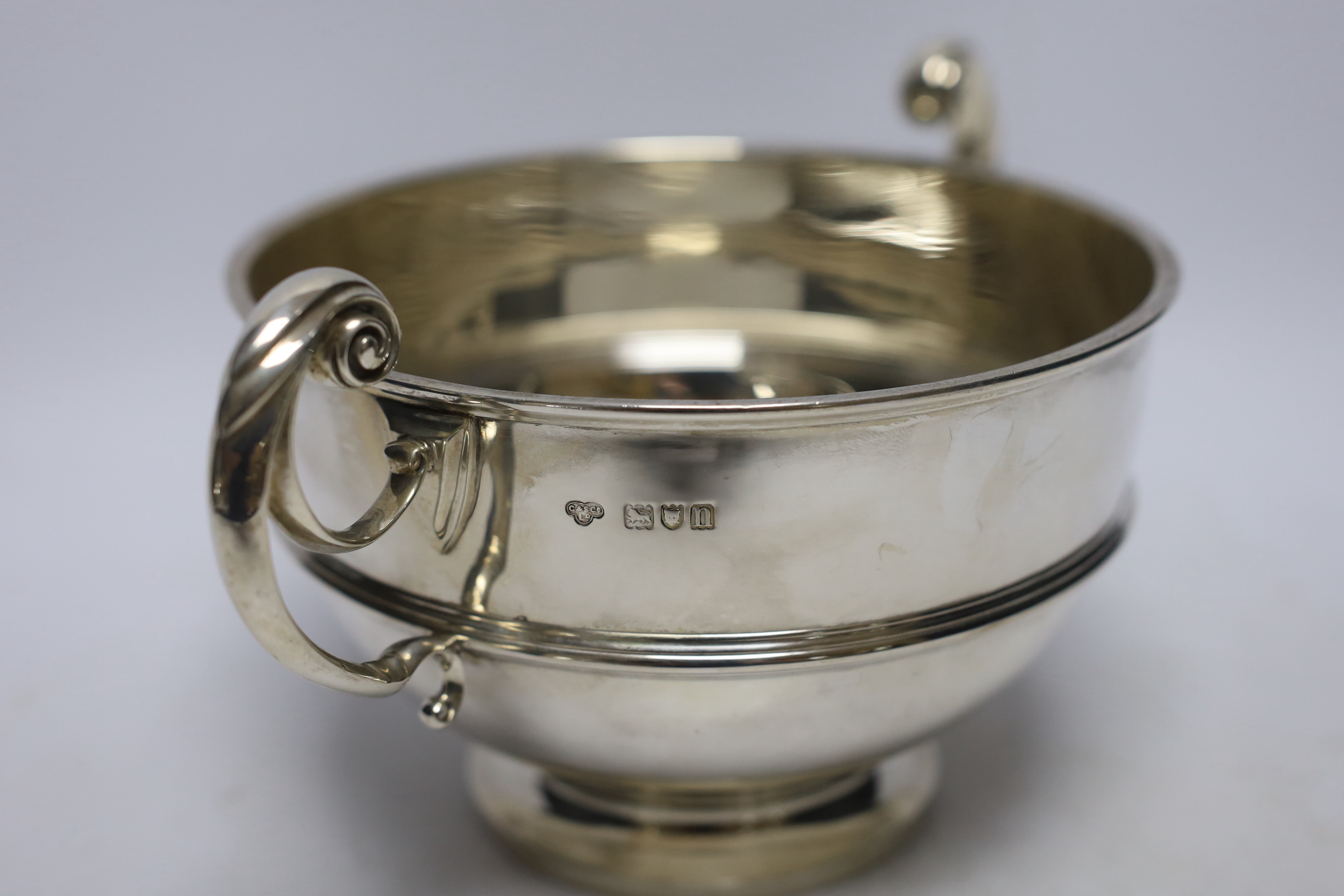 An Edwardian silver two handled bowl, with banded girdle, Goldsmiths & Silversmiths Co Ltd, London, 1908, 27cm over handles, 18.5oz.